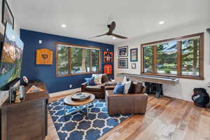 Living room featuring ceiling fan and light hardwood / wood-style floors