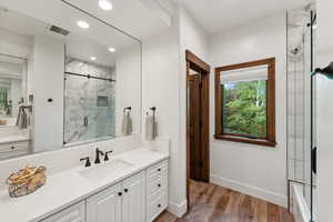 Bathroom featuring hardwood / wood-style floors and vanity