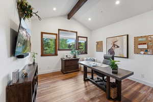 Office space featuring vaulted ceiling with beams and light wood-type flooring