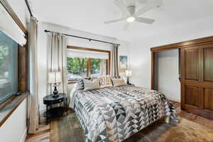 Bedroom with ceiling fan and hardwood / wood-style flooring