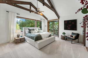 Carpeted bedroom featuring access to outside, multiple windows, ceiling fan, and beamed ceiling