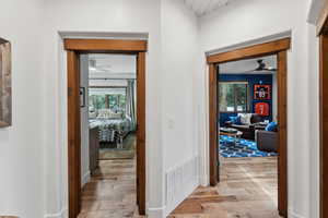 Hall with light hardwood / wood-style floors