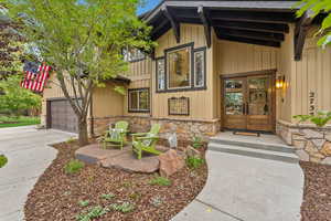 Doorway to property featuring french doors and a garage