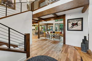 Foyer featuring beamed ceiling and hardwood / wood-style flooring