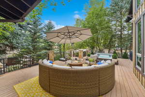 Wooden terrace featuring an outdoor living space and an outdoor hot tub