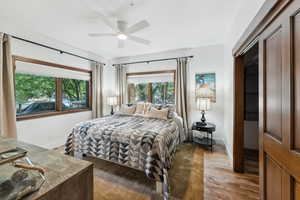 Bedroom featuring ceiling fan, a closet, and hardwood / wood-style flooring