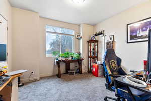 Carpeted office space with a textured ceiling