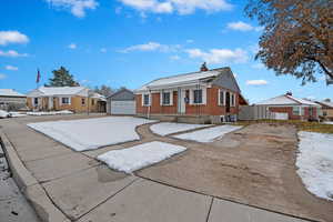 View of front of house with central AC unit, a garage, and an outdoor structure