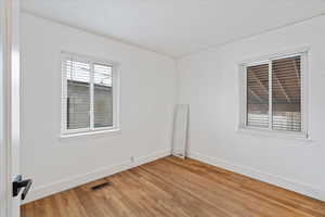 Empty bedroom with wood-type flooring