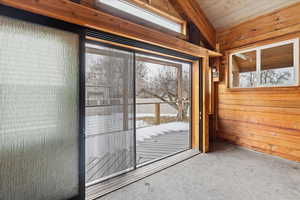 Large sliding glass door leading to composite deck from the pool house