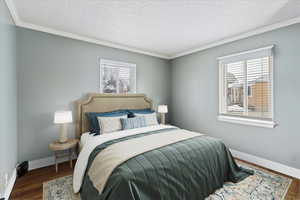 Virtual staged bedroom with dark hardwood / wood-style flooring, and multiple windows