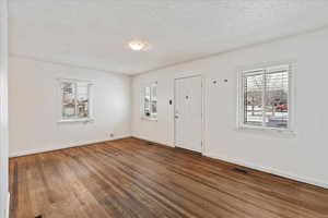 Foyer with hardwood floors, and lots of natural light