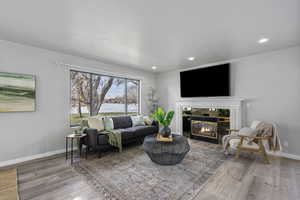 Living room featuring a tile fireplace and hardwood / wood-style flooring