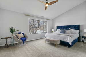 Bedroom with ceiling fan, carpet floors, and lofted ceiling