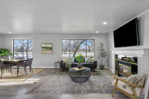 Living room featuring a high end fireplace and light hardwood / wood-style floors