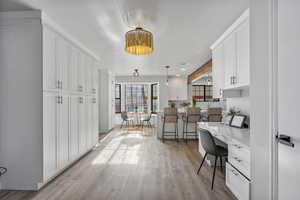 Home office featuring built in desk and light hardwood / wood-style flooring