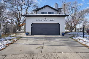 View of snow covered exterior with a garage