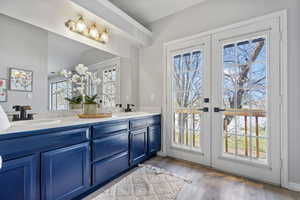 Bathroom featuring hardwood / wood-style flooring, vanity, and french doors