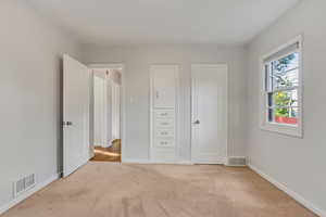 Unfurnished bedroom featuring light carpet