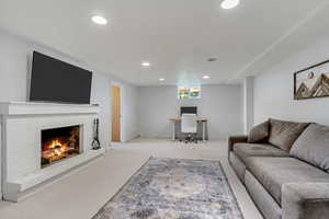 Living room with a fireplace and light colored carpet