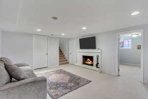 Living room featuring a fireplace and light carpet