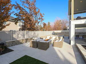 View of patio with an outdoor fire pit