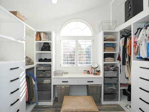 Primary Walk-In Closet, built in storage and vanity and natural light