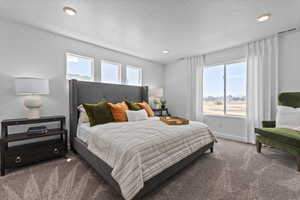 Bedroom featuring carpet and a textured ceiling