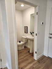 Bathroom featuring hardwood / wood-style flooring and toilet