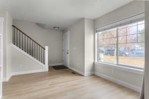 Entrance foyer featuring a wealth of natural light and light hardwood / wood-style flooring