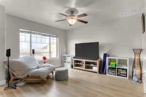 Sitting room with ceiling fan and light hardwood / wood-style floors