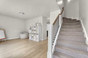 Stairs with hardwood / wood-style floors