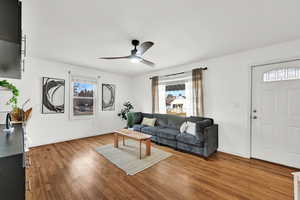 Living room featuring hardwood / wood-style floors and ceiling fan