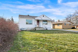 Bungalow-style home with a front lawn