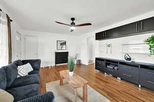 Living room featuring hardwood / wood-style flooring and ceiling fan