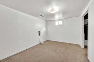 Basement with light colored carpet