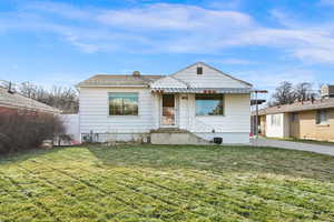 Bungalow-style home with a front lawn