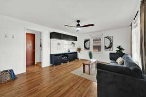 Living room featuring ceiling fan and hardwood / wood-style floors