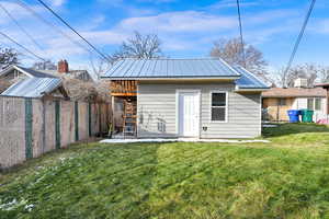 View of outbuilding with a yard