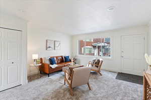 Carpeted living room with ornamental molding