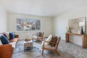 Sitting room featuring crown molding and light colored carpet