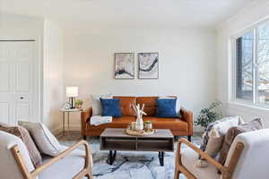 Living room featuring carpet and crown molding