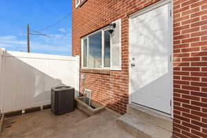 Doorway to property with central air condition unit