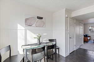 Dining space with crown molding and a textured ceiling