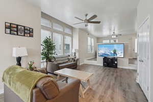 Living room featuring ceiling fan and light hardwood / wood-style floors