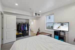 Bedroom featuring light carpet and a closet