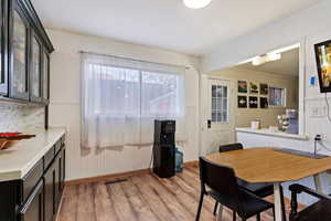 Dining room featuring light wood-type flooring, radiator, and ornamental molding