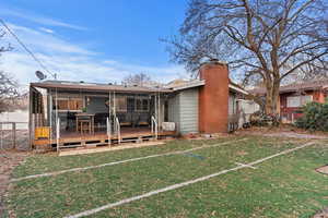 Rear view of property featuring a lawn