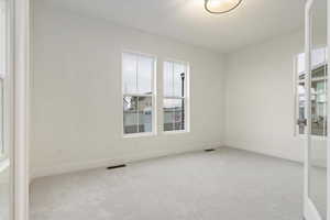 Spare room with light colored carpet