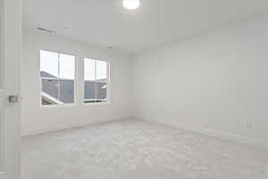 Unfurnished room with light colored carpet